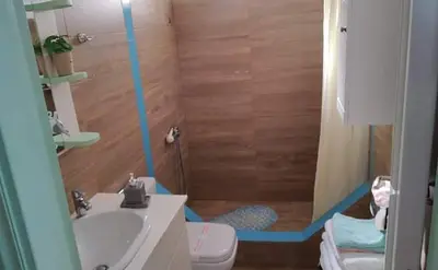 a bathroom with a shower and a sink and a toilet at Ornella's & Laura's secret place in Livadia
