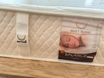 a mattress on a shelf with a picture of a baby at Stegna Sunny Beach- up floor in Archangelos