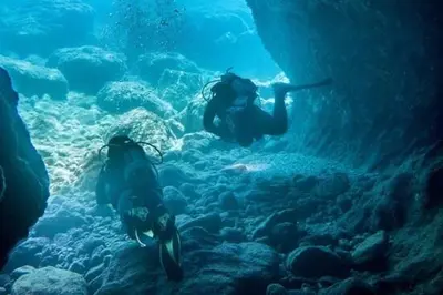 two people are swimming in an underwater aquarium at Stegna Sunny Beach- up floor in Archangelos