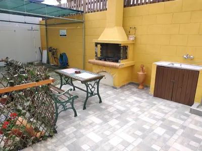 a patio with a table and a stove in a kitchen at Casa Georgia in Faliraki