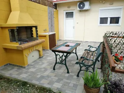 a patio with a grill and a table and a stove at Casa Georgia in Faliraki