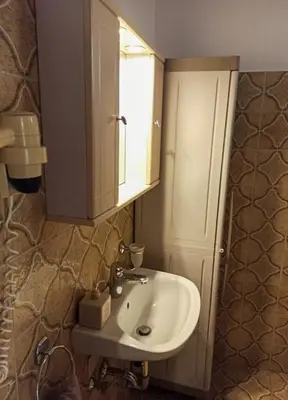 a bathroom with a sink and a medicine cabinet at Casa Georgia in Faliraki