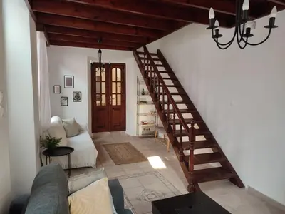 a living room with a staircase and a couch at Old Town Maisonette in Rhodes Town