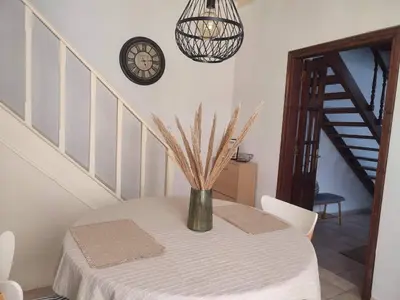 a vase on a table in a room with a staircase at Old Town Maisonette in Rhodes Town
