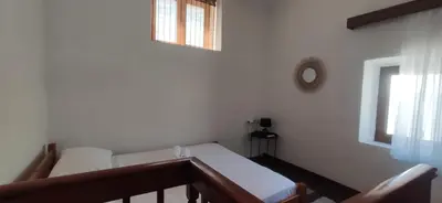 a white room with a bed and a window at Old Town Maisonette in Rhodes Town