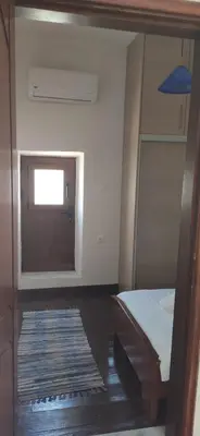 a room with a bed and a door and a rug at Old Town Maisonette in Rhodes Town