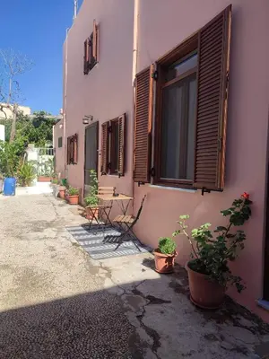 a building with potted plants on the side of it at Old Town Maisonette in Rhodes Town
