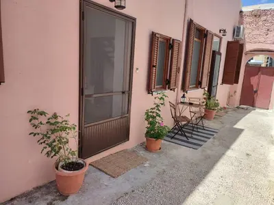 a door of a building with potted plants next to it at Old Town Maisonette in Rhodes Town