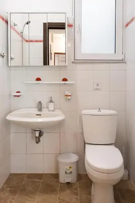 a bathroom with a toilet and a sink at Kamelia Apartment in Rhodes Town