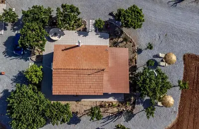 an overhead view of a building with trees around it at G & M Beach House in Haraki