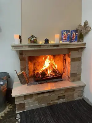 a brick fireplace with a fire in it at Green Sunshine in Theologos
