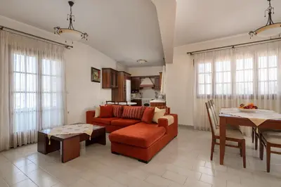 a living room with a couch and a table at Green Sunshine in Theologos
