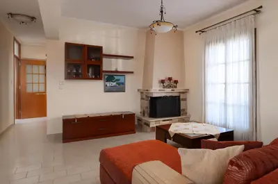 a living room with a couch and a tv at Green Sunshine in Theologos
