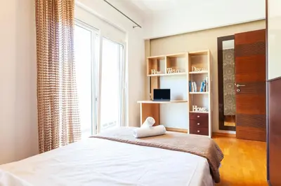 a bedroom with a bed and a large window at Unique Sea & Sunset Residence in Ixia