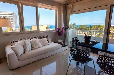 a living room with a couch and some windows at Unique Sea & Sunset Residence in Ixia
