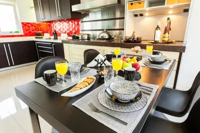 a kitchen with a table with food and drinks on it at Unique Sea & Sunset Residence in Ixia