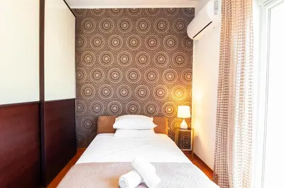 a bedroom with a bed with two towels on it at Unique Sea & Sunset Residence in Ixia