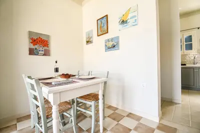 a white table with two chairs and a computer on it at Ponente in Symi
