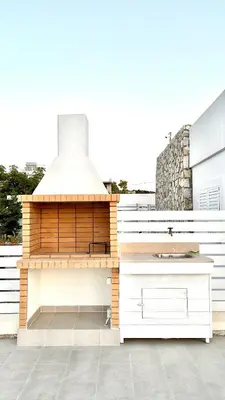 a barbecue on the roof of a house at Vaso Beach Front Villa in Ialyssos