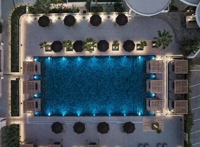 an overhead view of a swimming pool at night at Ammades All Suites Beach Hotel & Spa - Adults Only in Faliraki