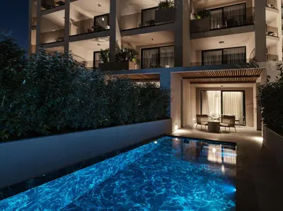 a swimming pool in front of a building at night at Ammades All Suites Beach Hotel & Spa - Adults Only in Faliraki