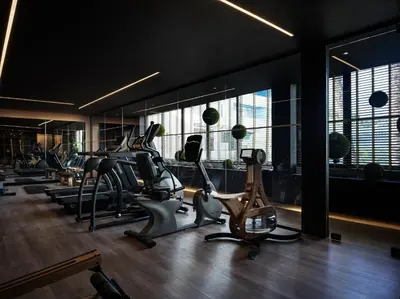 a gym with treadmills and elliptical machines at Ammades All Suites Beach Hotel & Spa - Adults Only in Faliraki