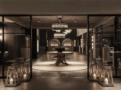 a room with a table and a chandelier and candles at Ammades All Suites Beach Hotel & Spa - Adults Only in Faliraki