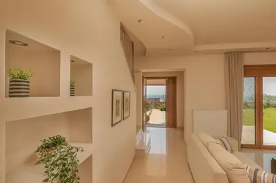 a living room with a couch and a window at Majestic View Villa in Kolimbia