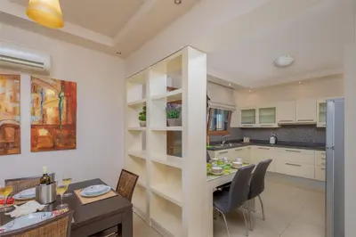 a kitchen and dining room with a table and chairs at Majestic View Villa in Kolimbia