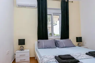 a bedroom with two beds and a window at Lana's House in Rhodes Town