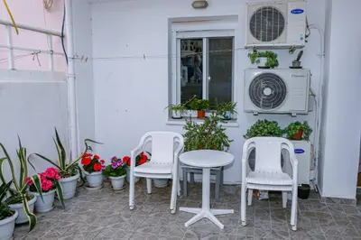 a patio with two chairs and a table and some plants at Lana's House in Rhodes Town