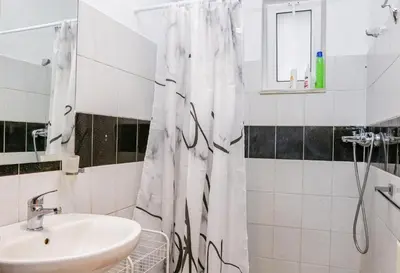 a bathroom with a sink and a shower curtain at Lana's House in Rhodes Town