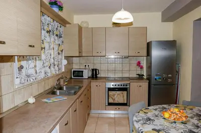 a kitchen with a sink and a refrigerator and a table at Lana's House in Rhodes Town