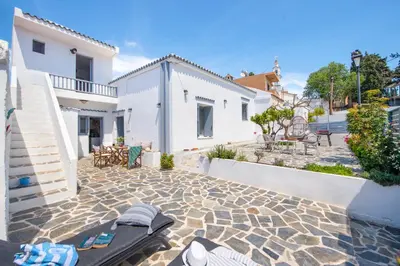 a backyard with a stone patio and a house at Traditional Dream House in Soroni