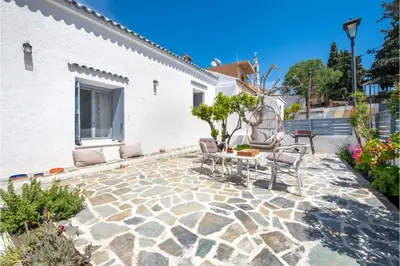 a patio with chairs and a table next to a building at Traditional Dream House in Soroni