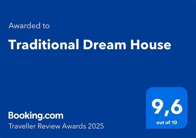 a blue sign with the text translated to traditional dream house at Traditional Dream House in Soroni