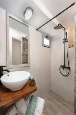 a bathroom with a white sink and a shower at Traditional Dream House in Soroni