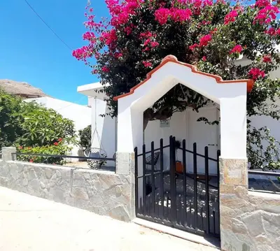 a gate to a house with pink flowers at Annika's Summer Dream in Livadia