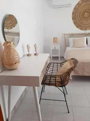 a room with a desk and a bed and a mirror at Annika's Summer Dream in Livadia