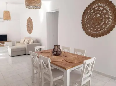 a dining room table and chairs in a living room at Annika's Summer Dream in Livadia