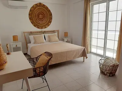 a bedroom with a bed and a table and chairs at Annika's Summer Dream in Livadia