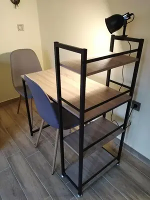 a wooden table with a chair and a shelf at Serafi Cozy Rooms in Archangelos