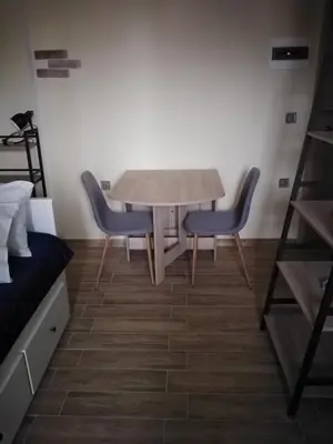 a dining room table and two chairs in a room at Serafi Cozy Rooms in Archangelos