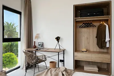 a room with a desk and a chair and a window at Maison A Rhodes with 66m2 heated pool on a 4800m2 plot in Koskinou