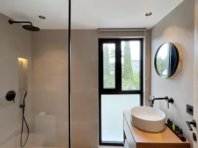 a bathroom with a sink and a shower at Maison A Rhodes with 66m2 heated pool on a 4800m2 plot in Koskinou
