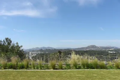 a view of a field with mountains in the background at Maison A Rhodes with 66m2 heated pool on a 4800m2 plot in Koskinou