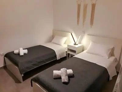 two beds in a small room with towels on them at Kalavarda Cosy Home 2 in Kalavárda