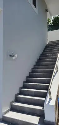 a set of stairs next to a white building at Kalavarda Cosy Home 2 in Kalavárda