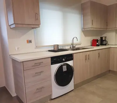 a kitchen with a washing machine and a sink at Kalavarda Cosy Home 2 in Kalavárda