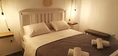 a bedroom with a large bed with two white pillows at Kalavarda Cosy Home 2 in Kalavárda
